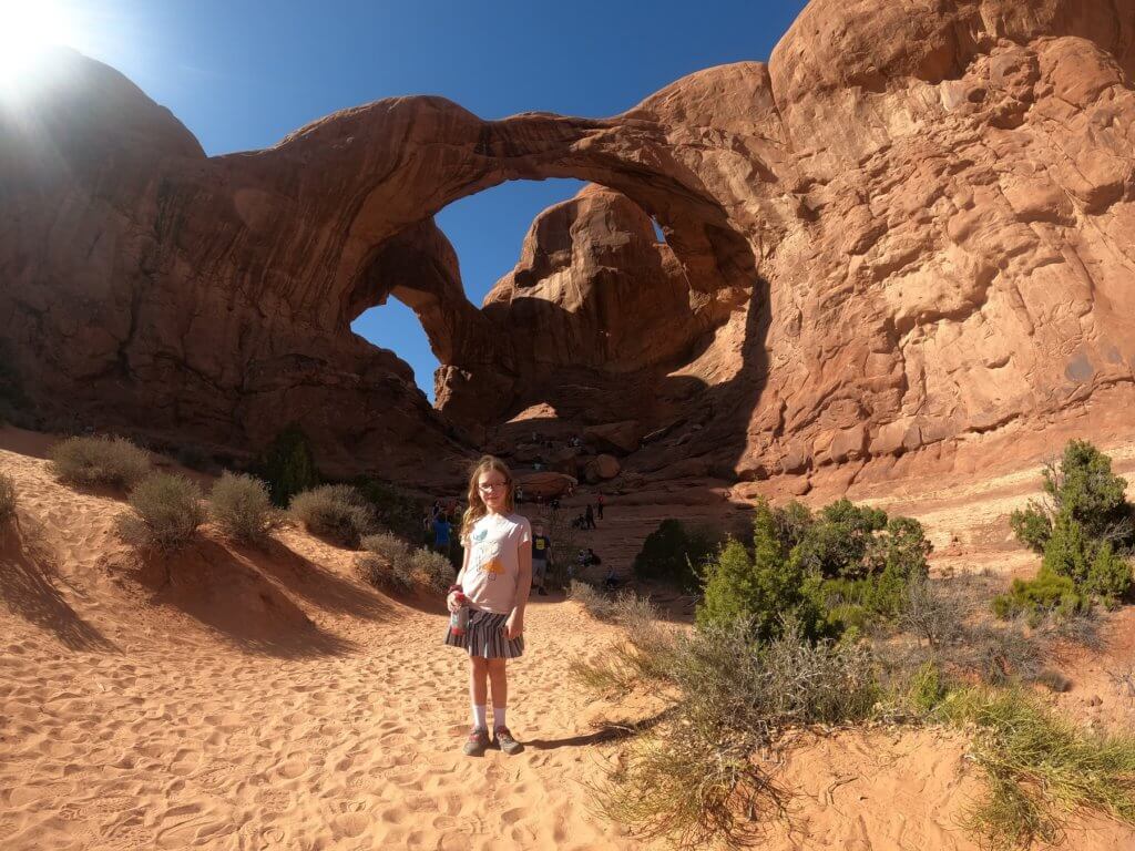 girl in front of arches
