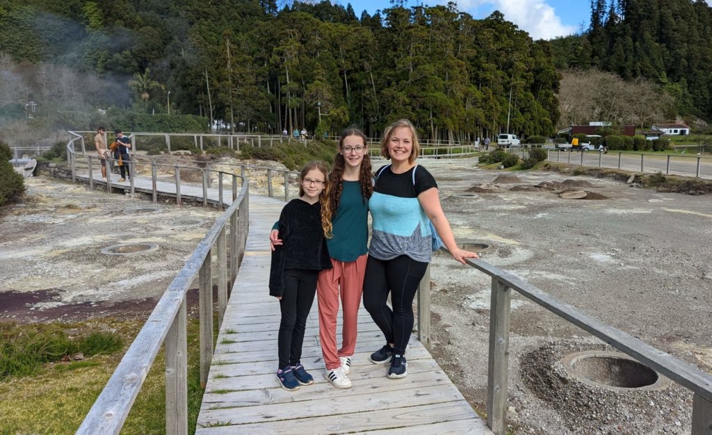 three people on a boardwalk