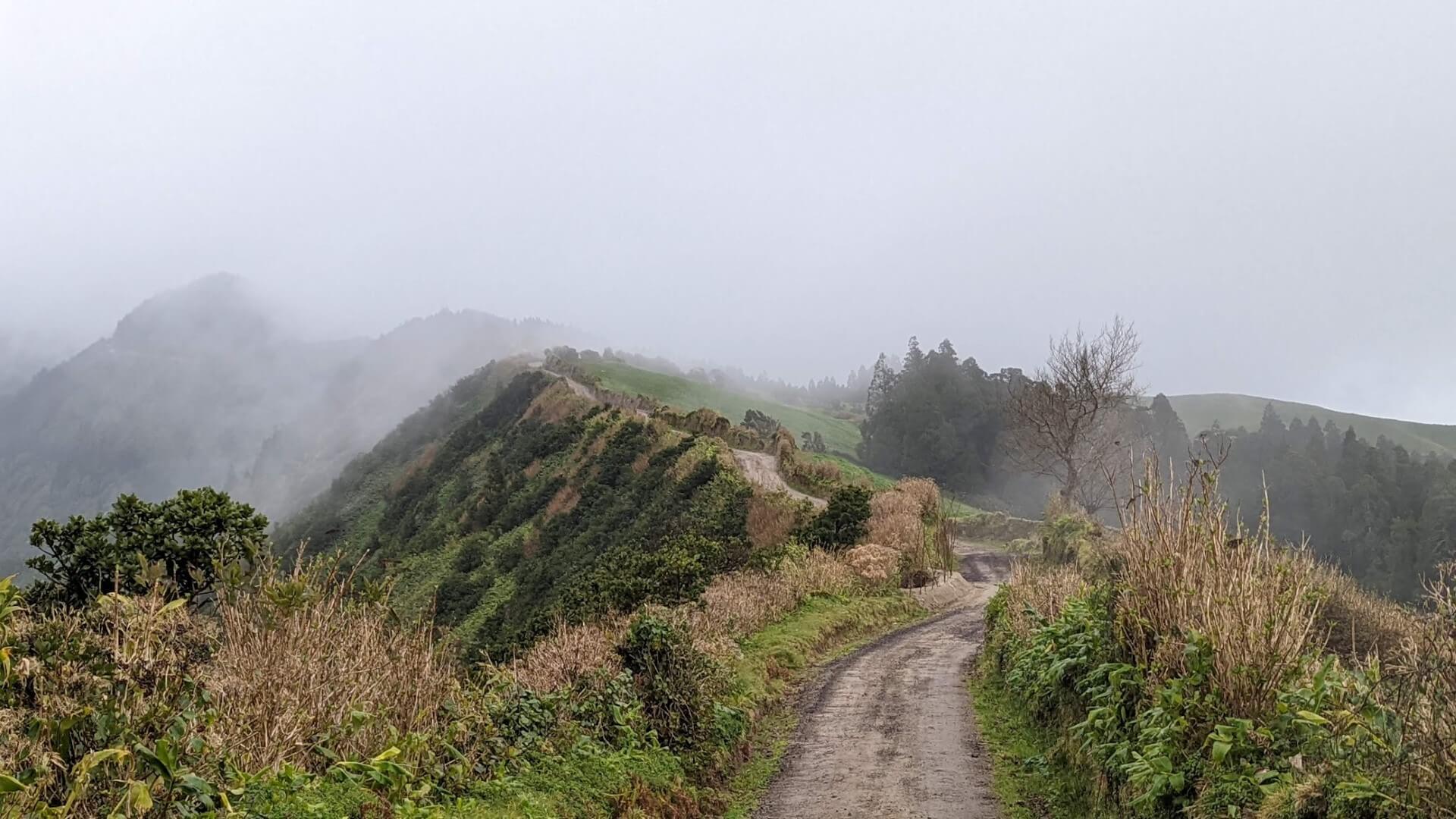 trail on mountain ridge in fog