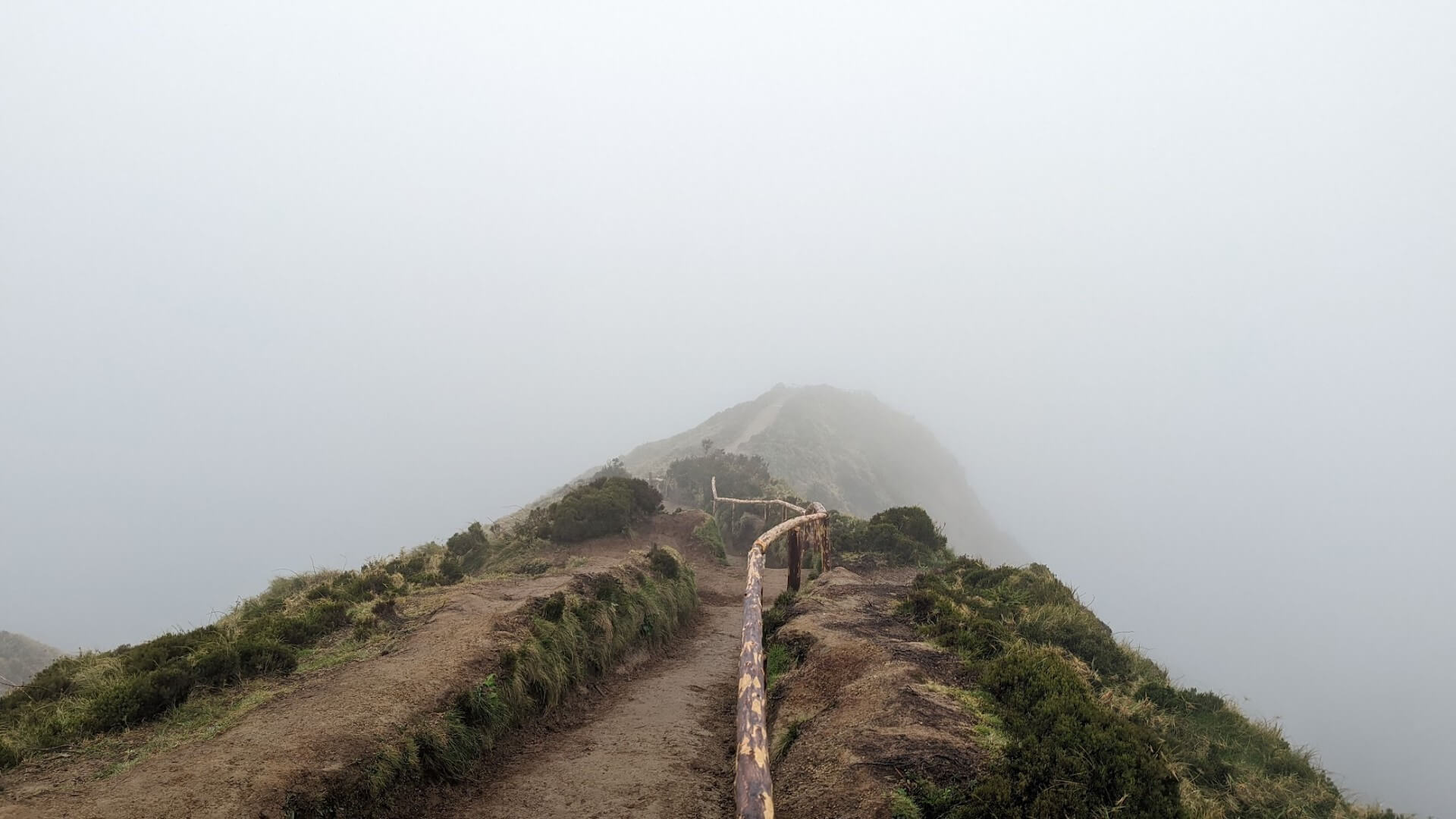 trail on mountain ridge in fog