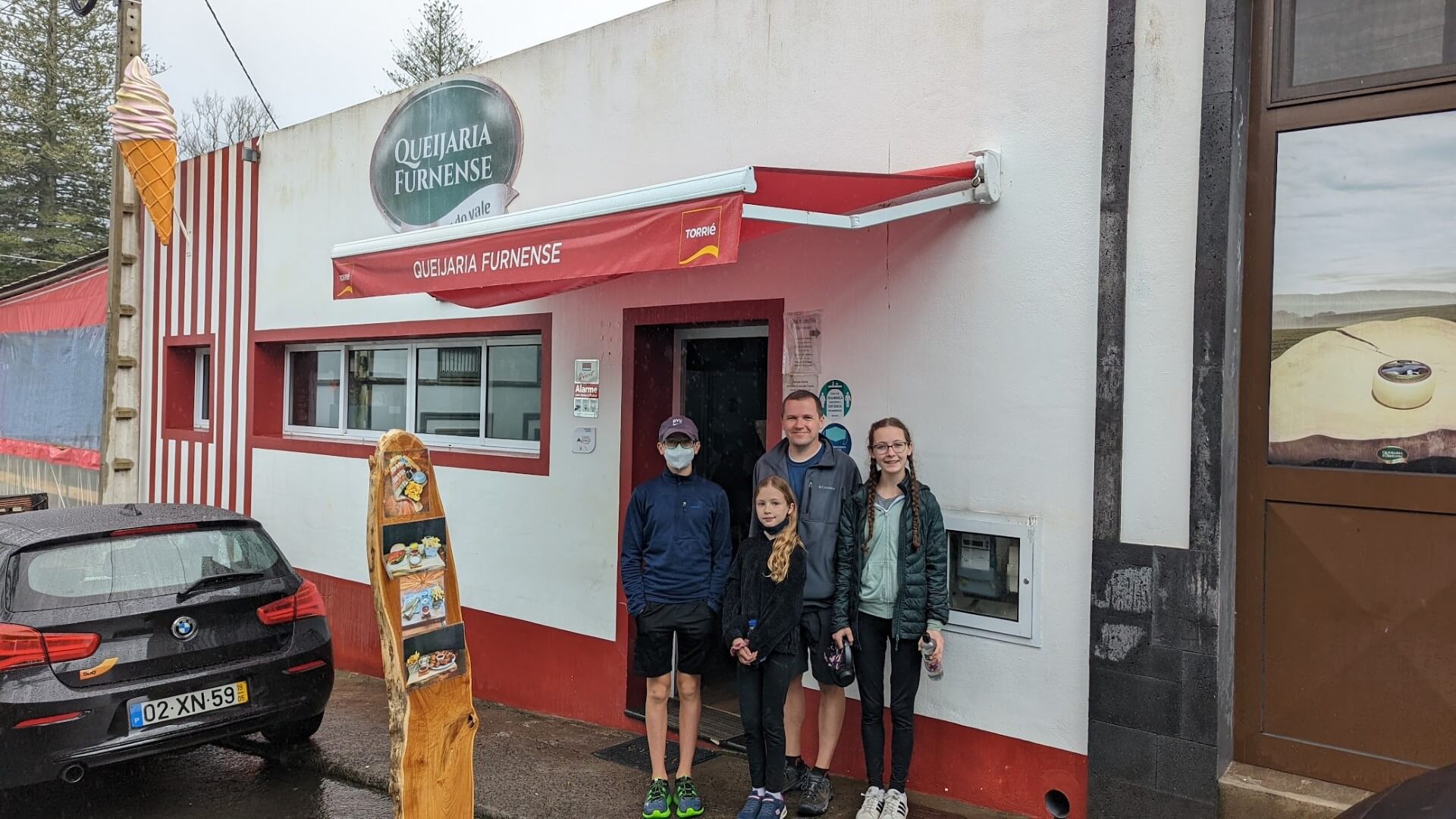 family in front of store