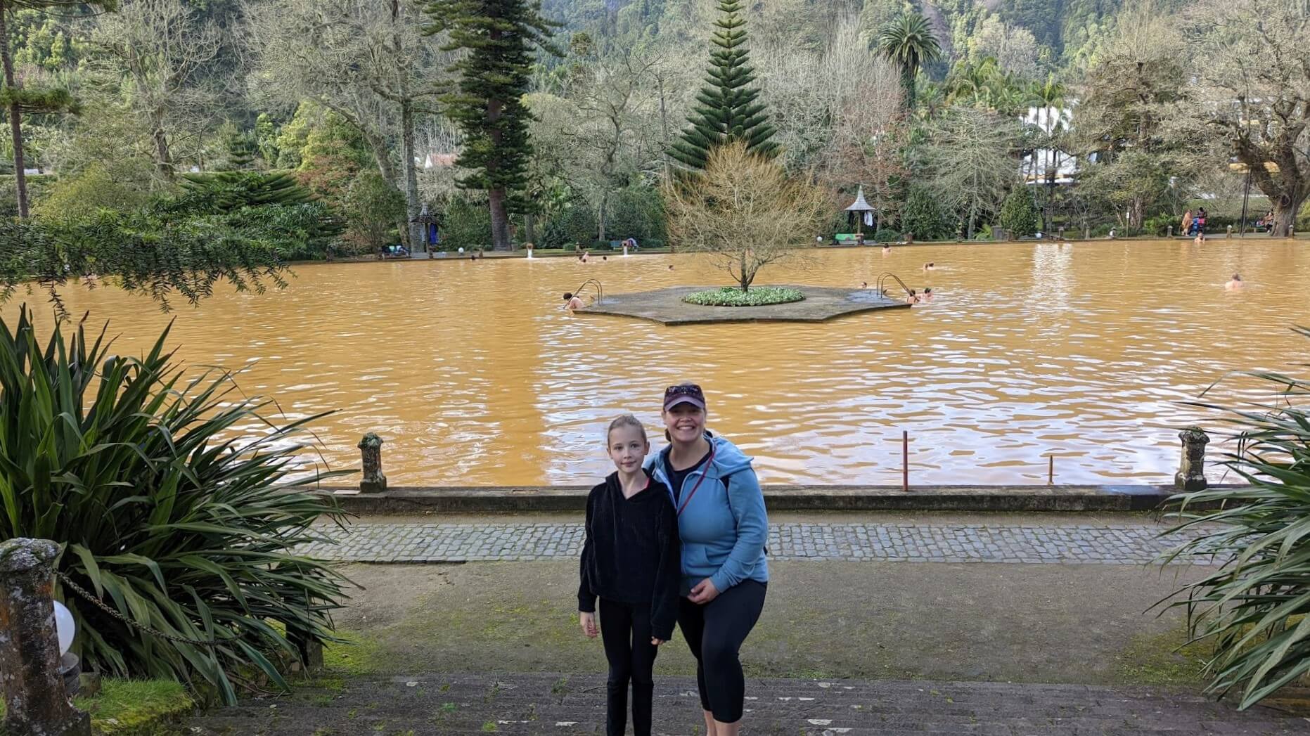 woman and girl in front or orange pool