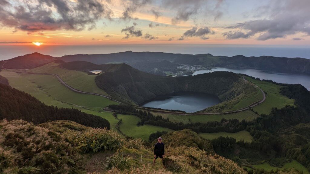 boy in front of cater lake and sunset